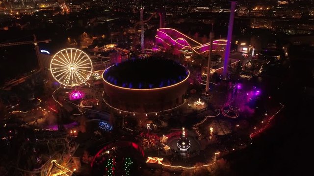 Wide dynamic aerial shot of Linnanm&auml;ki Finland Six flags in the evening by night during light carneval