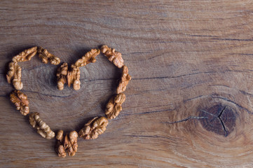 Obraz na płótnie Canvas brown heart of walnut on a wooden oak board