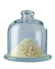 Pyramid of rice in a transparent glass container isolated on white