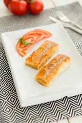 Turkish traditional food fast breakfast "borek" with cheese "hellim" and tomato 