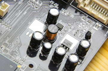  black computer board with electrolytic capacitors and inductance coil, microcontroller, smd circuit
