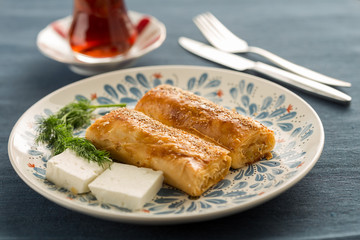 Turkish fast breakfast with borek and tomato,cucumber, and pepper
