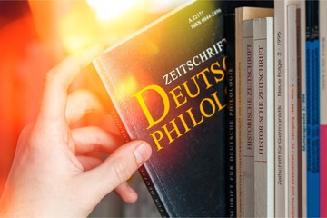 Hand holds book law book legal system library law library research