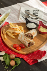 gourmet sliced tortilla roll, burittos, meat wraps with French fries