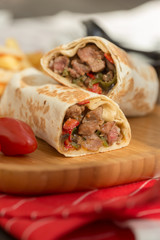 gourmet sliced tortilla roll, burittos, meat wraps with French fries