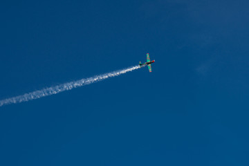 Old vintage military plane in blue sky on aviashow