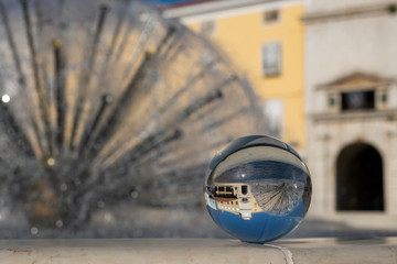 Fototapeta na wymiar Fountain through glass sphere in the city of Cres on a sunny day in spring