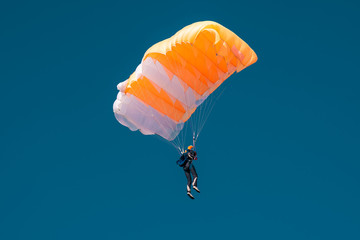 Colorful parachute in blue sky on aviashow