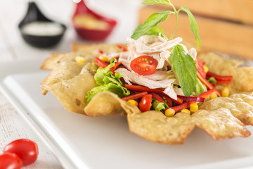 Taco Salad in a Tortilla Bowl with chicken and peppers 