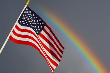 Obraz premium american flag of united states of america with rainbow 