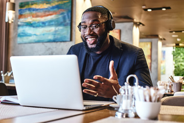 Work until you no longer need to introduce yourself. Young businessman with headphones sitting in...