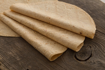 Lavash, tortilla, lavaş, flat and thin bread on table 