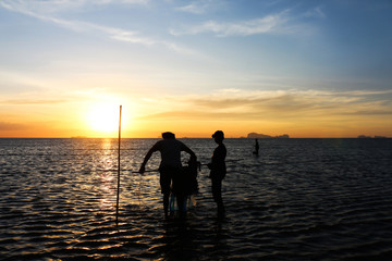 silhouette of fisherman family.