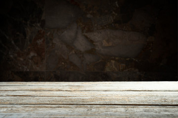 Old wooden table with brick background dark
