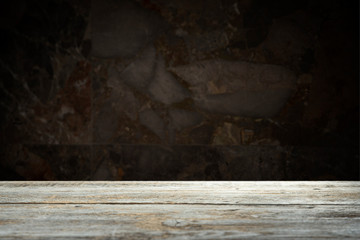 Old wooden table with brick background dark