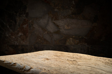 Old wooden table with brick background dark