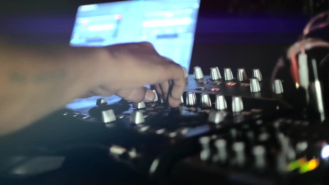 People dancing on the bar, DJ playing music using a laptop program.