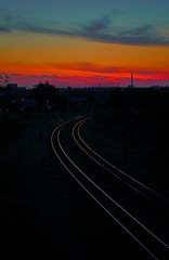 Fototapeta na wymiar Railroad leaving into the distance on a background of red sunset