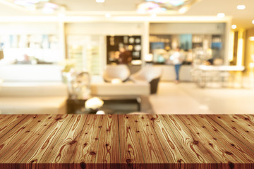 Empty wooden table top with blurred of coffee shop, cafe, bar background, Abstract background can be used for display or montage your products.