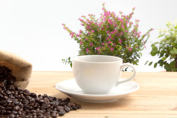  black coffee with beans isolated on wood background