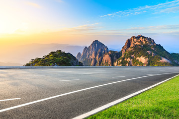 Asphalt highway road and beautiful huangshan mountains nature landscape at sunrise