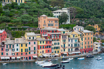 Fototapeta na wymiar Portofino Italy. 04-29-2019. Boats and colored houses at Portofino, Italy