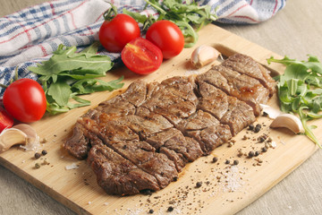 A beef steak well done with vegetables