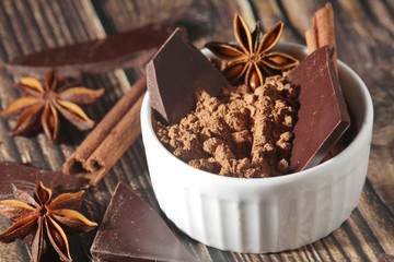Cocoa powder and a bar of dark chocolate