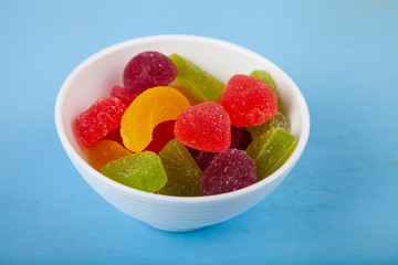 Multicolored marmalade in a white bowl