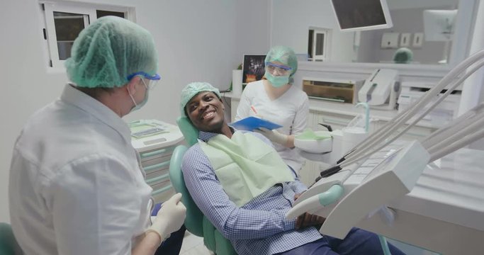 black patient talks about himself dentist listen