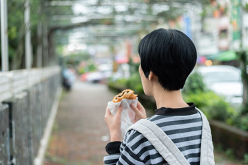 woman eat traditional Taiwanese snack