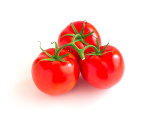 three tomatoes on a branch isolated on a white background