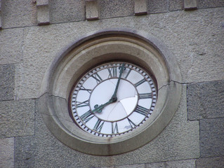 Fototapeta premium Background clock in the stone wall of the city