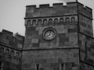Fototapeta na wymiar Background clock in the stone wall of the city