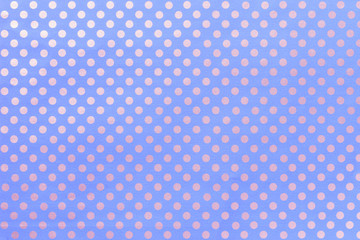 Light blue background from wrapping paper with a pattern of silver polka dot closeup.