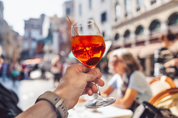 Man's hand with a glass of aperol