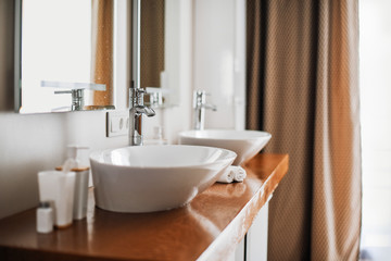Naklejka na ściany i meble Modern stylish washbasins with chrome taps. Contemporary interior. Luxury lifestyle. Wood texture
