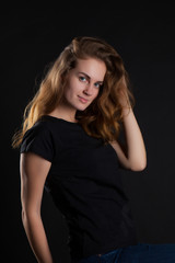 Fototapeta na wymiar closeup portrait of a young, beautiful woman on a black background