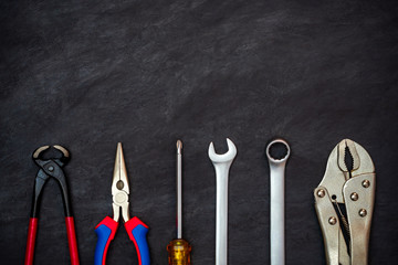 Craftsman tool on black cement background. Copy space for your text. Concept of maintenance to be reused as before.