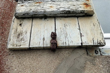 Wooden painted shutters background with peeling paint