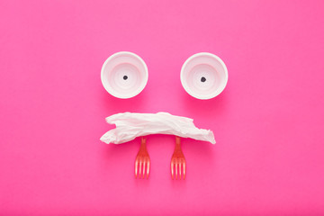 Sad ecological reality. Plastic garbage monster on pink background. Environmental protection. Copy...