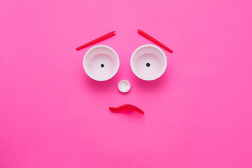 Disturbing ecological reality. Plastic garbage monster face on pink background. Zero waste lifestyle. Copy space.