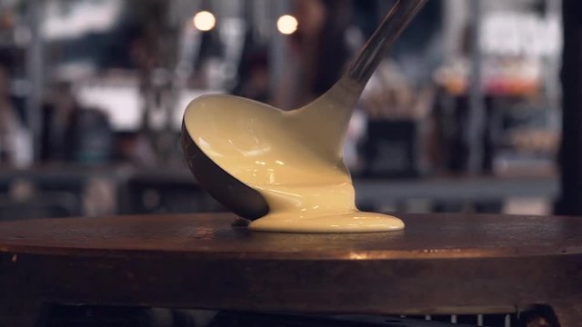 Slow motion of pouring  crepe doe on a metal griddle