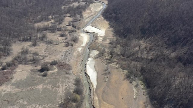 Mining drainage waste on river coast 4K drone video