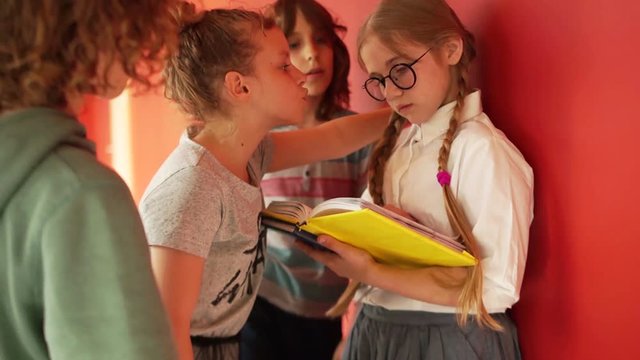 Girl hooligan offends his classmate honors pupil. Teenage bullying, moral violence at school