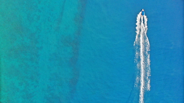 Aerial. Speedy boat sailing by sea. Top view, copy space.