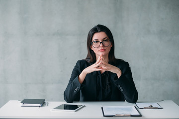 Fototapeta premium Leadership and successful career. Portrait of powerful business woman in eyeglasses, with confident facial expression.