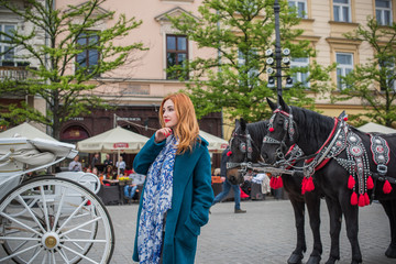  Tourism concept. Beautiful woman look at view of city streets, centre of city. Vacation in  Krakow