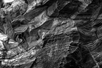 Natural black volcanic stone texture venetian plaster background. Dark volcanic rock venetian plaster stone texture grain pattern. Black grunge charcoal background texture rock