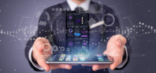Businessman holding Smartphone with user interface data on the screen isolated on a background